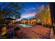 Backyard pool with brick patio, desert landscaping and lounge seating at dusk at 19054 N 97Th Pl, Scottsdale, AZ 85255