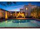 A beautiful backyard pool at dusk with a built-in grill and a covered patio area at 19054 N 97Th Pl, Scottsdale, AZ 85255