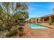 Resort-style pool area with brick pavers, lounge chairs, and lush landscaping for a tranquil outdoor oasis at 19054 N 97Th Pl, Scottsdale, AZ 85255