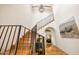 A bright foyer with a staircase features hardwood steps and black metal railings, enhanced by natural light at 19054 N 97Th Pl, Scottsdale, AZ 85255