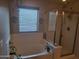 Bathroom featuring a soaking tub, a walk-in shower, and natural light from a window at 21013 W Wycliff Dr, Buckeye, AZ 85396