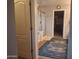 Bathroom features an enclosed glass shower, tan floors, and blue patterned area rug at 21013 W Wycliff Dr, Buckeye, AZ 85396