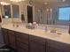 Bathroom featuring double sinks, a large mirror, and a separate shower area at 21013 W Wycliff Dr, Buckeye, AZ 85396