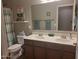 Bathroom featuring double sinks, a large mirror, and decorative accents throughout the space at 21013 W Wycliff Dr, Buckeye, AZ 85396