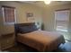 Cozy bedroom featuring a comfortable bed, two windows and neutral walls at 21013 W Wycliff Dr, Buckeye, AZ 85396