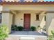 Inviting front porch with neutral siding, comfortable seating, and beautiful desert landscaping at 21013 W Wycliff Dr, Buckeye, AZ 85396