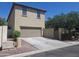 Beige stucco exterior elevation showing garage, driveway, and partial landscaping at 21013 W Wycliff Dr, Buckeye, AZ 85396