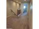Hallway featuring carpeted floors, wood railing and access to various rooms at 21013 W Wycliff Dr, Buckeye, AZ 85396