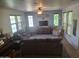 Comfortable living room featuring a ceiling fan, and multiple windows for natural light at 21013 W Wycliff Dr, Buckeye, AZ 85396