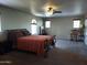 Inviting main bedroom with neutral walls, ceiling fan, and wrought iron bed frame at 21013 W Wycliff Dr, Buckeye, AZ 85396