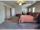 Spacious main bedroom featuring neutral walls, ceiling fan, and comfortable carpeting at 21013 W Wycliff Dr, Buckeye, AZ 85396