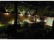 Evening view of the backyard patio, illuminated by landscape lighting, for relaxing outdoor entertainment at 21013 W Wycliff Dr, Buckeye, AZ 85396