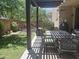 Relaxing covered patio with shade covering, dining table, chairs, and a manicured lawn at 21013 W Wycliff Dr, Buckeye, AZ 85396