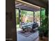 Covered patio with outdoor dining set, overlooking landscaped backyard at 21013 W Wycliff Dr, Buckeye, AZ 85396