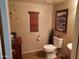 Well-lit powder room with wood blinds, neutral walls, tile flooring, and decorative accents at 21013 W Wycliff Dr, Buckeye, AZ 85396