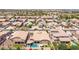 An aerial view displays a well-planned community with pools, landscaping, and street layout at 21275 E Russet Rd, Queen Creek, AZ 85142