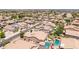 This aerial shot shows orderly neighborhood streets, varied house styles, and green yards at 21275 E Russet Rd, Queen Creek, AZ 85142