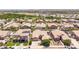 This aerial showcases a residential neighborhood with mature trees, lawns, and varied architecture at 21275 E Russet Rd, Queen Creek, AZ 85142