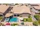 An aerial shot shows a backyard with a pool, spa, outdoor seating, and privacy wall at 21275 E Russet Rd, Queen Creek, AZ 85142