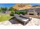 Relaxing backyard features stone fireplace, patio, and lounge chairs at 21275 E Russet Rd, Queen Creek, AZ 85142