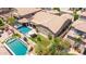 This backyard showcases a pool, spa, patio, and lush green landscaping at 21275 E Russet Rd, Queen Creek, AZ 85142