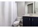 Bathroom features a white shower curtain and a dark vanity with drawers at 21275 E Russet Rd, Queen Creek, AZ 85142