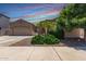 Gorgeous single-story home with a three-car garage, mature landscaping, and well manicured lawn at 21275 E Russet Rd, Queen Creek, AZ 85142