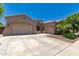 Stunning single-story home with well-manicured landscaping, three-car garage, and inviting curb appeal at 21275 E Russet Rd, Queen Creek, AZ 85142