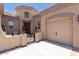 Charming front entry with a courtyard, seating area, and a three-car garage, offering privacy and convenience at 21275 E Russet Rd, Queen Creek, AZ 85142