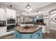 Open kitchen with center island, white cabinets, and tile backsplash at 21275 E Russet Rd, Queen Creek, AZ 85142
