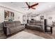 Open concept living room with tile flooring and comfortable grey sofas at 21275 E Russet Rd, Queen Creek, AZ 85142