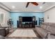 Inviting living room with blue accent wall and plush grey sofas at 21275 E Russet Rd, Queen Creek, AZ 85142