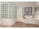 This primary bathroom offers a modern glass block shower partition and soaking tub under window at 21275 E Russet Rd, Queen Creek, AZ 85142