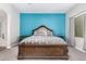 Bright main bedroom features a decorative accent wall and plush bedding with detailed wood frame at 21275 E Russet Rd, Queen Creek, AZ 85142