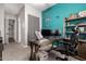 Office space featuring a desk, carpeted floors, and a bright blue accent wall at 21275 E Russet Rd, Queen Creek, AZ 85142