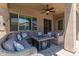 Covered patio offers a ceiling fan and comfortable seating around a fire pit, creating an inviting outdoor space at 21275 E Russet Rd, Queen Creek, AZ 85142