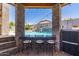 Outdoor pool bar seating overlooks the beautiful pool and adds to the entertaining options at 21275 E Russet Rd, Queen Creek, AZ 85142