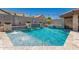 Beautiful pool with cascading water features, hot tub and travertine tile deck is perfect for entertaining at 21275 E Russet Rd, Queen Creek, AZ 85142