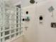 Close up of a glass block shower features showerhead, controls and shampoo and soap dispensers at 21275 E Russet Rd, Queen Creek, AZ 85142