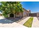 Cozy side yard with mature trees and an entry gate for added privacy at 21275 E Russet Rd, Queen Creek, AZ 85142