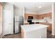 Modern kitchen features stainless steel appliances, island, and ample cabinet space at 22125 N 29Th Ave # 158, Phoenix, AZ 85027