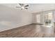 Spacious living room featuring sleek wood-look floors and a sliding glass door for ample natural light at 22125 N 29Th Ave # 158, Phoenix, AZ 85027