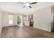Bright living room with hardwood floors and a ceiling fan transitions into an adjacent kitchen area at 22125 N 29Th Ave # 158, Phoenix, AZ 85027