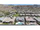 An aerial view shows a community with homes nestled against the backdrop of stunning desert mountains at 3118 E Gary Way, Phoenix, AZ 85042