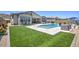 Beautiful backyard with lush lawn, pool, outdoor seating, and desert landscaping at 3118 E Gary Way, Phoenix, AZ 85042
