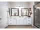 Stylish bathroom featuring dual sinks, a walk-in shower with a glass door, and white cabinets at 3118 E Gary Way, Phoenix, AZ 85042