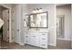 Well-lit bathroom with white cabinets, a granite countertop, a mirror, and a walk-in shower at 3118 E Gary Way, Phoenix, AZ 85042