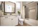 Bathroom with a white vanity, granite countertop, framed mirror, and shower-tub combo with white shower curtain at 3118 E Gary Way, Phoenix, AZ 85042