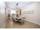 Elegant dining room with a long wood table, seating for eight, a chandelier, and wood-look tile flooring at 3118 E Gary Way, Phoenix, AZ 85042