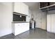 Garage with epoxy floors, custom storage cabinets, pegboard, and garage door at 3118 E Gary Way, Phoenix, AZ 85042